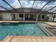 Beautiful screened-in pool area with fountains, a spa, and a covered patio area at 5074 Shore Side Dr, Lakeland, FL 33812