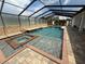 Gorgeous pool and spa enclosed in a screened lanai, featuring beautiful stone accents at 5074 Shore Side Dr, Lakeland, FL 33812