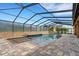 Relax by the screened-in pool and attached spa, surrounded by a paved patio for ultimate comfort and privacy at 5074 Shore Side Dr, Lakeland, FL 33812