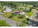 Aerial view of home with solar panels, large yard, and fencing at 1220 Woodland Ave, Lakeland, FL 33801