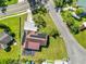 Birds eye view of home with solar panels and detached carport, and large yard at 1220 Woodland Ave, Lakeland, FL 33801