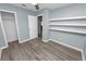 Clean bedroom with hard surface floors and shelving at 1220 Woodland Ave, Lakeland, FL 33801