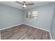 Cozy bedroom with hard surface floors and a window at 1220 Woodland Ave, Lakeland, FL 33801