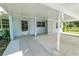 Large carport with access door on light blue home with white columns and lattice at 1220 Woodland Ave, Lakeland, FL 33801