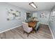 Charming dining room features modern light fixture and views to kitchen at 1220 Woodland Ave, Lakeland, FL 33801