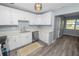 Updated kitchen with white cabinetry, stainless steel dishwasher, and quartz countertops at 1220 Woodland Ave, Lakeland, FL 33801