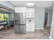 Open kitchen featuring stainless steel refrigerator and adjacent dining area at 1220 Woodland Ave, Lakeland, FL 33801