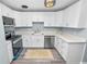 Bright kitchen featuring white cabinets, stainless steel appliances, and light countertops at 1220 Woodland Ave, Lakeland, FL 33801