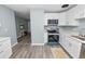 Modern kitchen showcasing white cabinets and stainless steel appliances at 1220 Woodland Ave, Lakeland, FL 33801