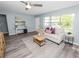 Stylish living room boasts modern flooring, a large window, neutral colors, and contemporary decor accents at 1220 Woodland Ave, Lakeland, FL 33801