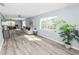 Spacious living room with modern flooring, ceiling fans, and bright windows providing ample natural light at 1220 Woodland Ave, Lakeland, FL 33801