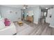 Bright living room with wood-look flooring, cozy furnishings, and open floor plan flowing to other rooms at 1220 Woodland Ave, Lakeland, FL 33801