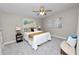 This main bedroom has a ceiling fan and modern decor at 217 S Kelly St, Lake Hamilton, FL 33851