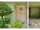 A welcoming front entrance features a charming wreath, potted ferns, and bright, natural light at 2203 Starboard Rd, Winter Haven, FL 33881