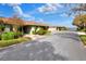 Picturesque street view of single-story homes with lush landscaping and serene lake views in the background at 2203 Starboard Rd, Winter Haven, FL 33881
