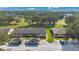Aerial view of the community showing well maintained lawns, mature trees, and covered parking at 2256 Firestone Pl, Winter Haven, FL 33884