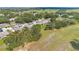 A peaceful residential community amidst lush greenery and open spaces, as seen from above at 2256 Firestone Pl, Winter Haven, FL 33884