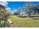 Expansive backyard with mature trees and lush greenery creating a serene outdoor space at 2256 Firestone Pl, Winter Haven, FL 33884