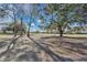 Large, open backyard with mature trees providing shade at 2256 Firestone Pl, Winter Haven, FL 33884