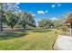 Spacious backyard with mature trees and green grass at 2256 Firestone Pl, Winter Haven, FL 33884