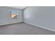 Light blue bedroom with gray carpet and a window at 2256 Firestone Pl, Winter Haven, FL 33884