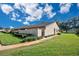 Charming villa featuring lush landscaping, private courtyard, and covered front entry at 2256 Firestone Pl, Winter Haven, FL 33884