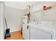 Bright laundry room with washer, dryer, and extra shelving at 2256 Firestone Pl, Winter Haven, FL 33884