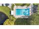 Community pool with lounge chairs and lush landscaping at 2256 Firestone Pl, Winter Haven, FL 33884