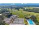 Aerial view showing tennis courts and refreshing pool at 2256 Firestone Pl, Winter Haven, FL 33884