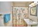 Updated bathroom with pedestal sink and shower/tub combo at 415 W Beacon Rd, Lakeland, FL 33803