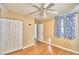 Bedroom with wood floors, ceiling fan and double door closet at 415 W Beacon Rd, Lakeland, FL 33803