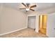 Spacious bedroom with ceiling fan, closet, and access to bathroom at 415 W Beacon Rd, Lakeland, FL 33803