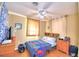 Bright bedroom with wood floors, ceiling fan, and window coverings at 415 W Beacon Rd, Lakeland, FL 33803