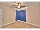 Well-lit bedroom featuring neutral walls, ceiling fan and blue curtains at 415 W Beacon Rd, Lakeland, FL 33803