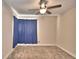 Bright bedroom with neutral walls, ceiling fan and blue curtains at 415 W Beacon Rd, Lakeland, FL 33803