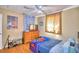 Cozy bedroom with wood floors, ceiling fan, and ample closet space at 415 W Beacon Rd, Lakeland, FL 33803