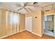Bedroom with wood floors, ceiling fan, and adjacent bathroom access at 415 W Beacon Rd, Lakeland, FL 33803