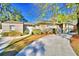 Charming ranch home with a long driveway and mature landscaping at 415 W Beacon Rd, Lakeland, FL 33803
