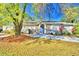 Attractive ranch home with mature landscaping and a paved driveway at 415 W Beacon Rd, Lakeland, FL 33803