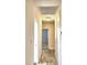 Long hallway with light walls and wood-look tile floors at 415 W Beacon Rd, Lakeland, FL 33803