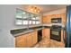 Bright kitchen with granite countertops, wood cabinets, and tile flooring at 415 W Beacon Rd, Lakeland, FL 33803