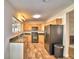 Modern kitchen featuring granite countertops, wood cabinets, and tile flooring at 415 W Beacon Rd, Lakeland, FL 33803