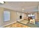 Living room with stone fireplace, patio access, and tiled floors at 415 W Beacon Rd, Lakeland, FL 33803