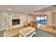 Living room with stone fireplace and view of the patio at 415 W Beacon Rd, Lakeland, FL 33803
