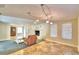 Spacious living room with a stone fireplace, leather seating, and tile floors at 415 W Beacon Rd, Lakeland, FL 33803