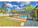 Inviting screened pool area with patio and brick decking at 415 W Beacon Rd, Lakeland, FL 33803