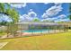 Screened-in pool with lounge chairs and lush lawn at 415 W Beacon Rd, Lakeland, FL 33803