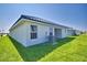 A well-maintained backyard features an air conditioning unit, tile roof and a lush green lawn at 4682 Grandview Glen Dr, Auburndale, FL 33823