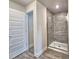 Bathroom with wood flooring and glass-enclosed shower at 4682 Grandview Glen Dr, Auburndale, FL 33823