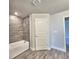 Bathroom featuring a tub with tiled walls and modern fixtures, perfect for relaxation at 4682 Grandview Glen Dr, Auburndale, FL 33823